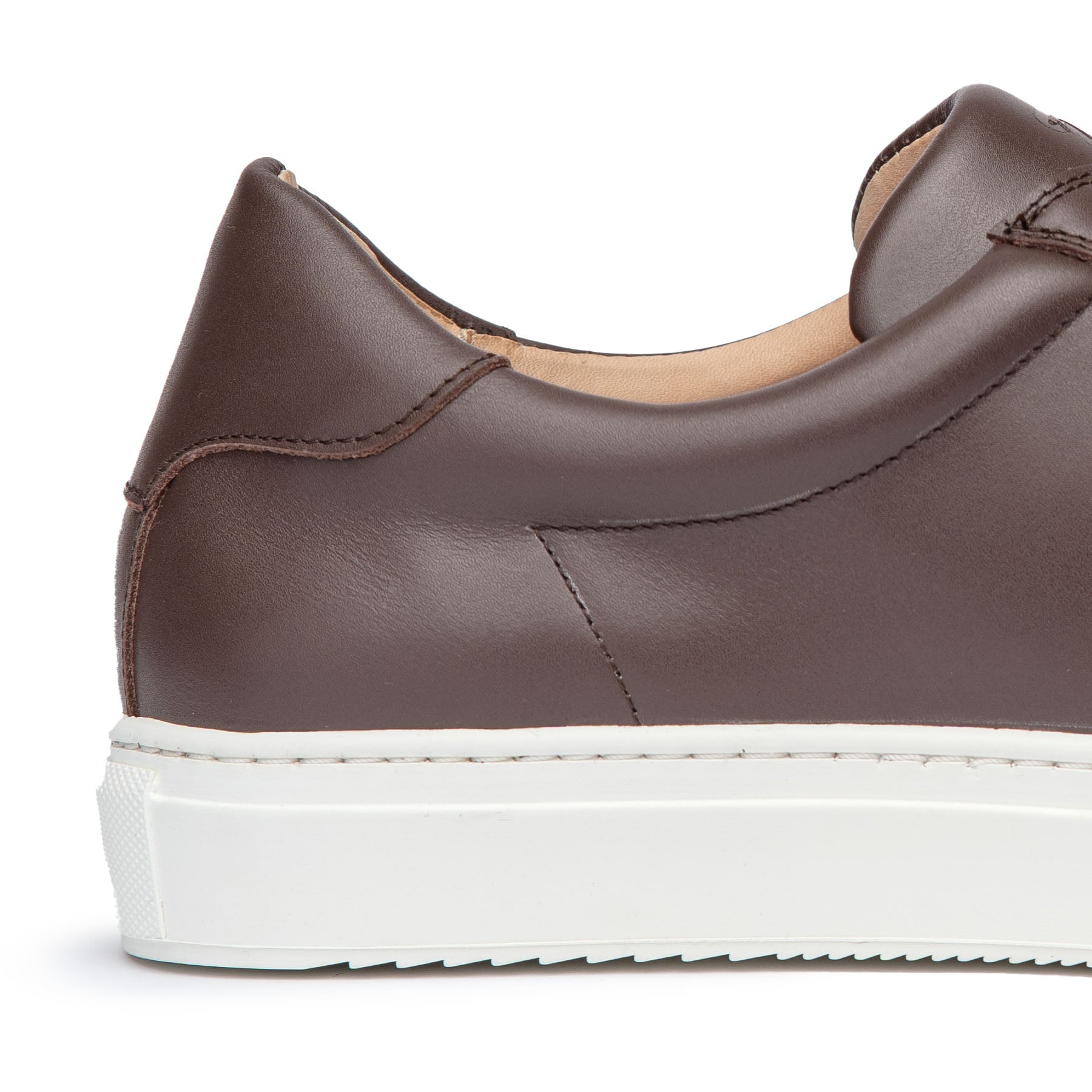 Brown dress sneakers featuring minimalist design and rubber sole