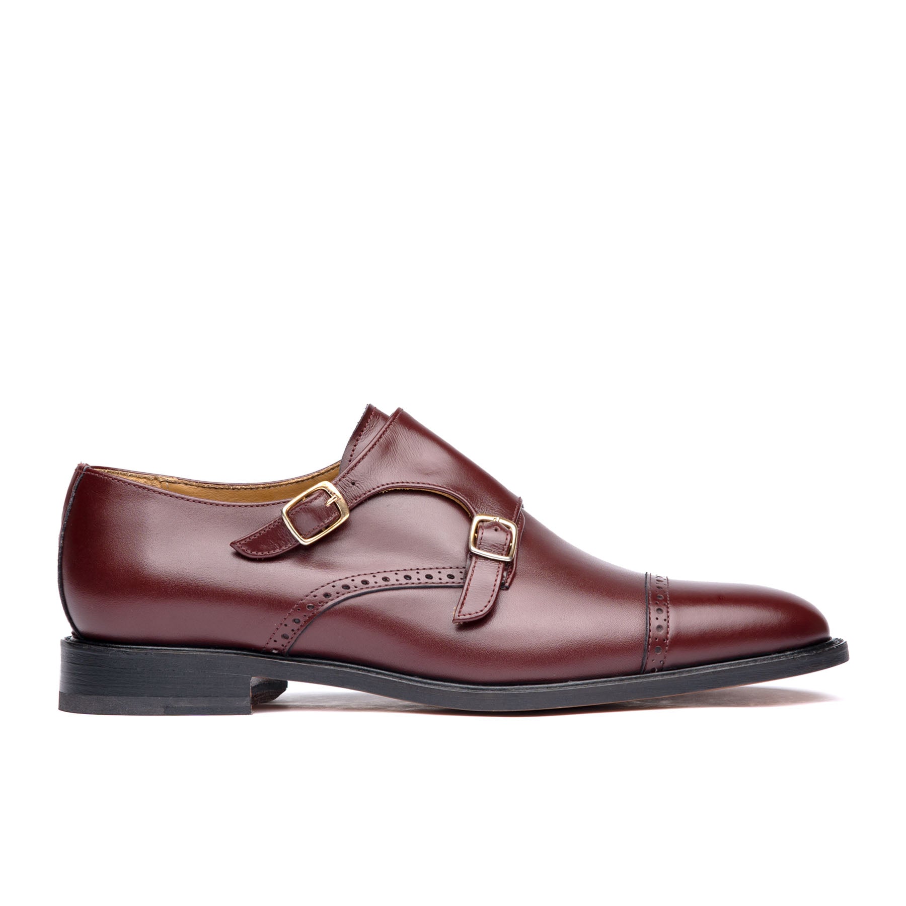 Burgundy monk strap shoes with double buckles and brogues at the cap toe