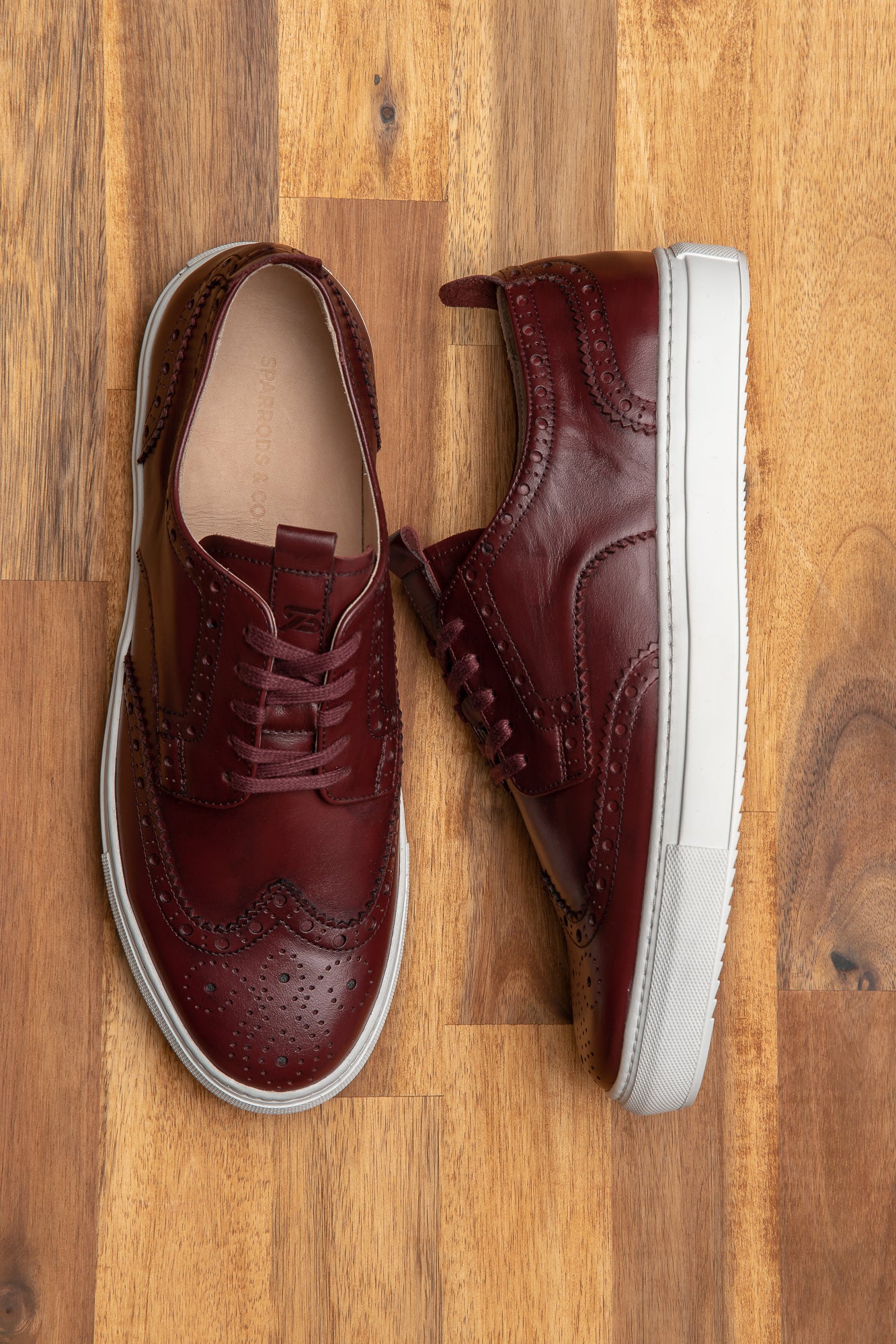 The Alpha burgundy wingtip sneakers are perfect casual staple for men