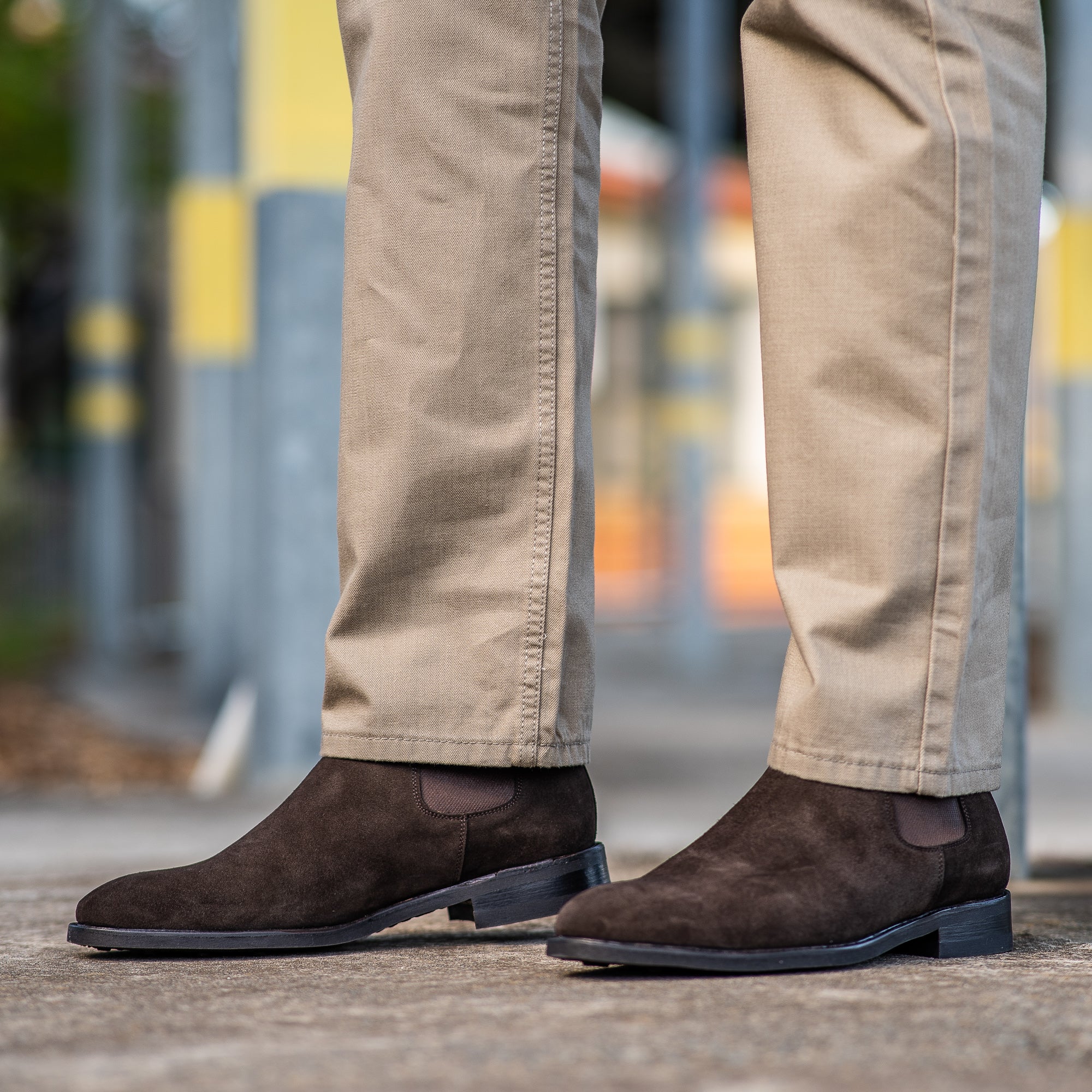 Mens brown suede chelsea boots paired with beige chinos for the office