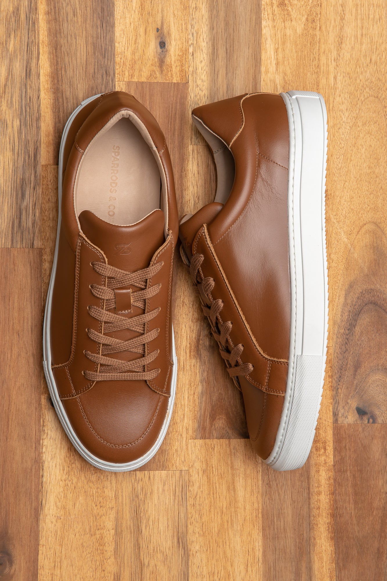 Dress up sneakers mens featuring tan leather upper with cotton waxed lace and rubber sole