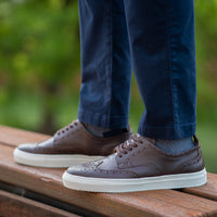 Chino slim fit pants with striped shirts paired with the leather brogue wingtip leather sneakers in dark brown.