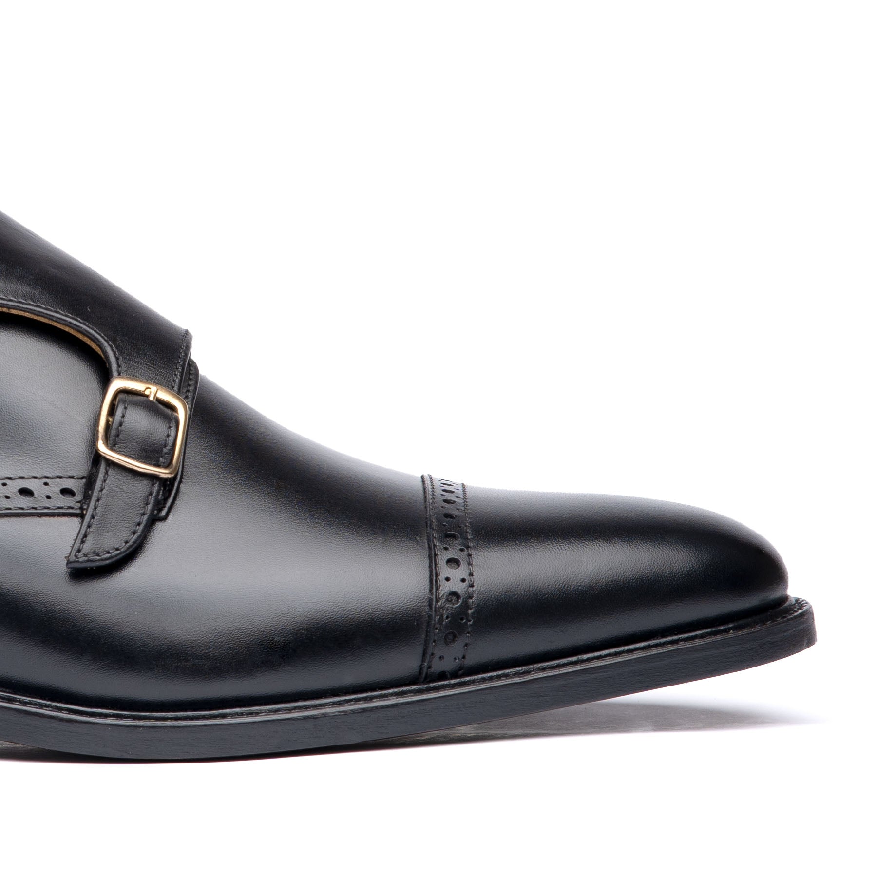 Black double strap monk shoes with brogues at the cap toe with offset buckles for official events