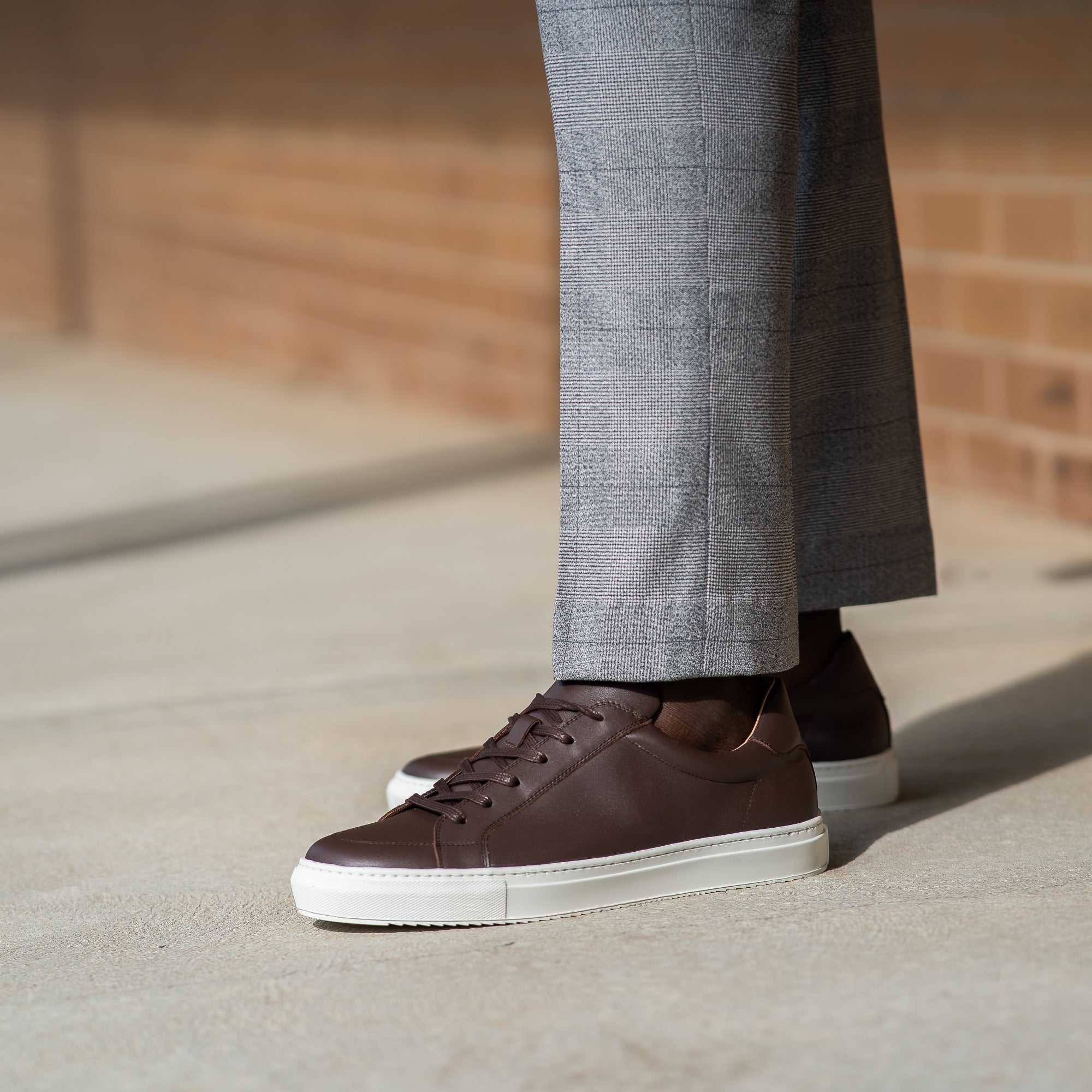 Men brown sneakers immaculately styled with business suit