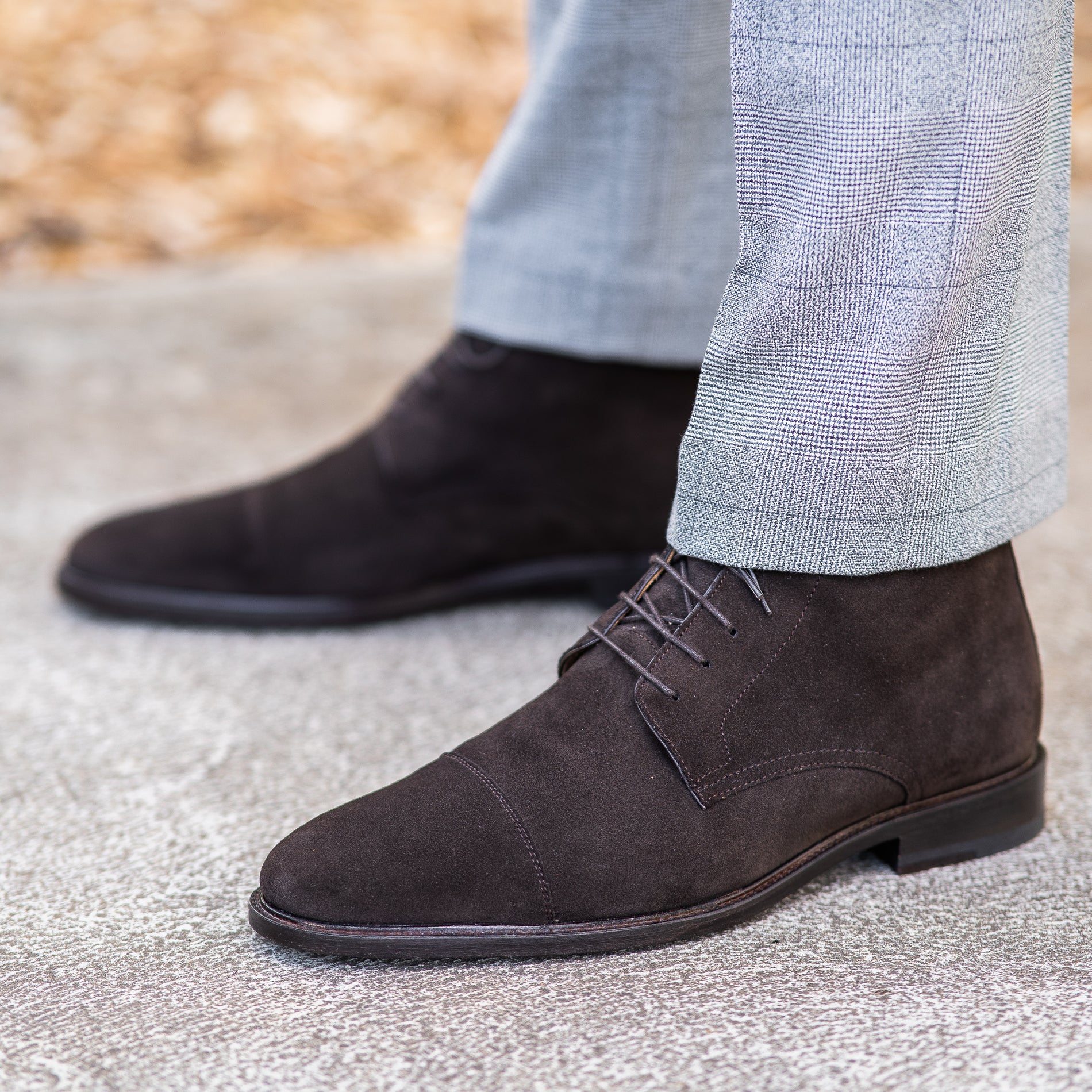 Mens brown suede dress boots styled nicely with beige dress pant and knit jacket for business events