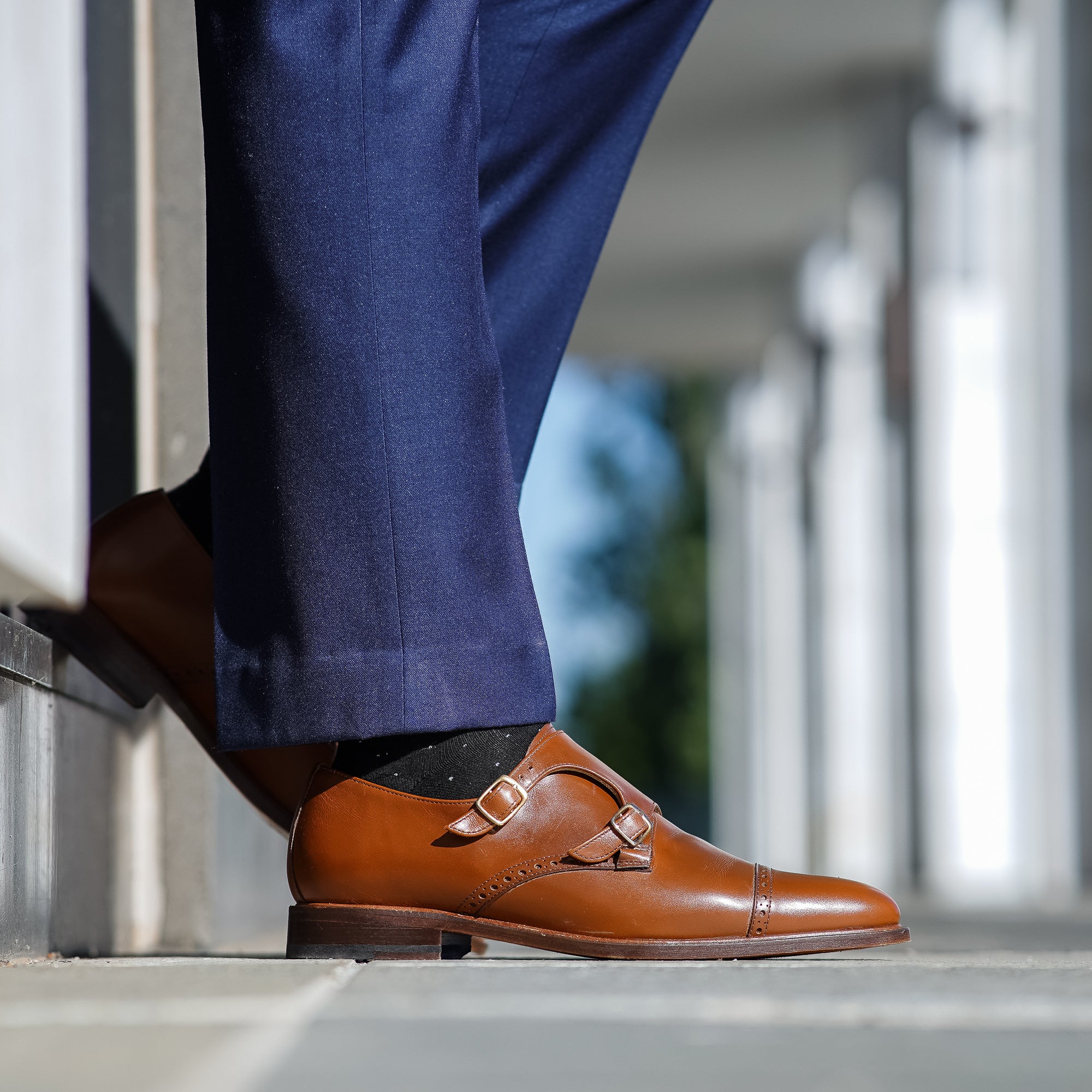 Tan monk strap shoes paired with navy blue suits and tuxedo