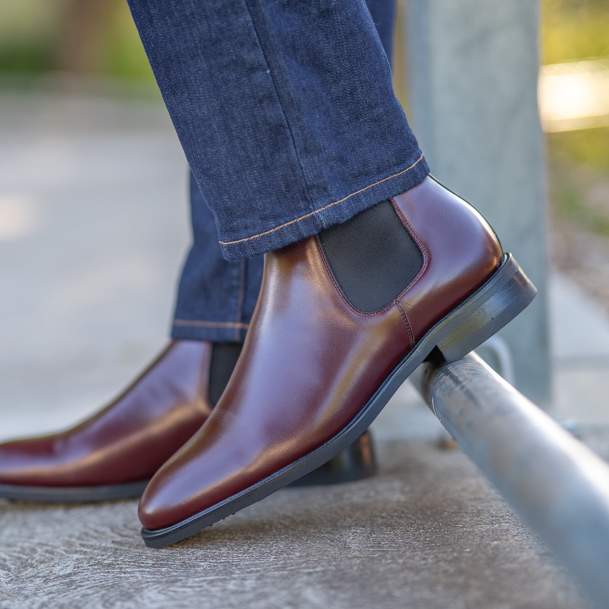 Burgundy chelsea boots oxblood styled with blue jeans and blazer for weekend adventure