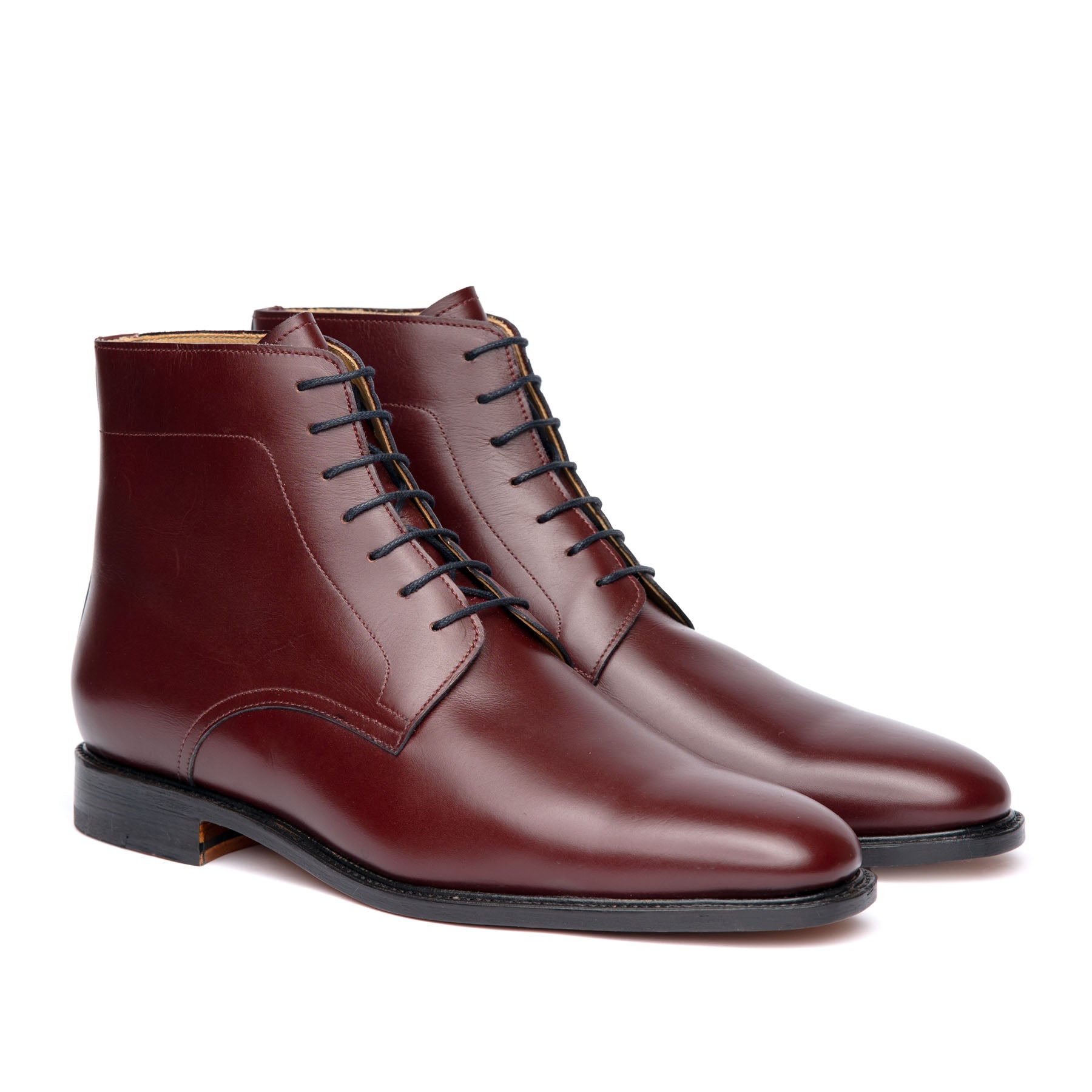 Burgundy leather boots featuring open lace system, full grain leather and 7 blind eyelets