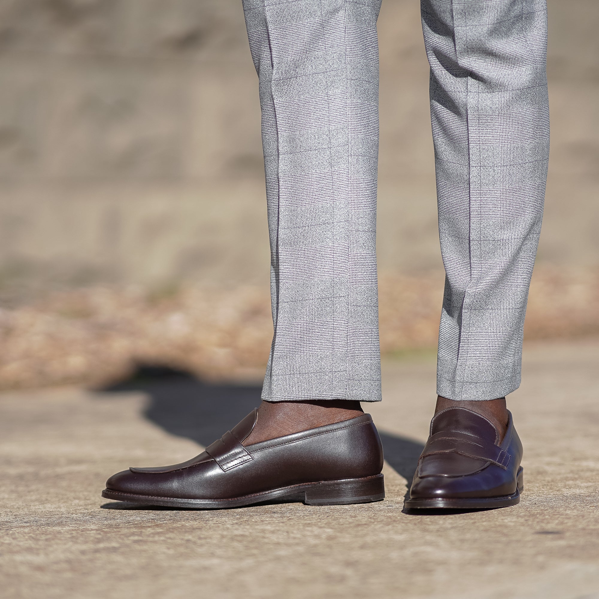 Mens brown dress loafers paired with slim fit merino wool suits and worn sockless for trendy look