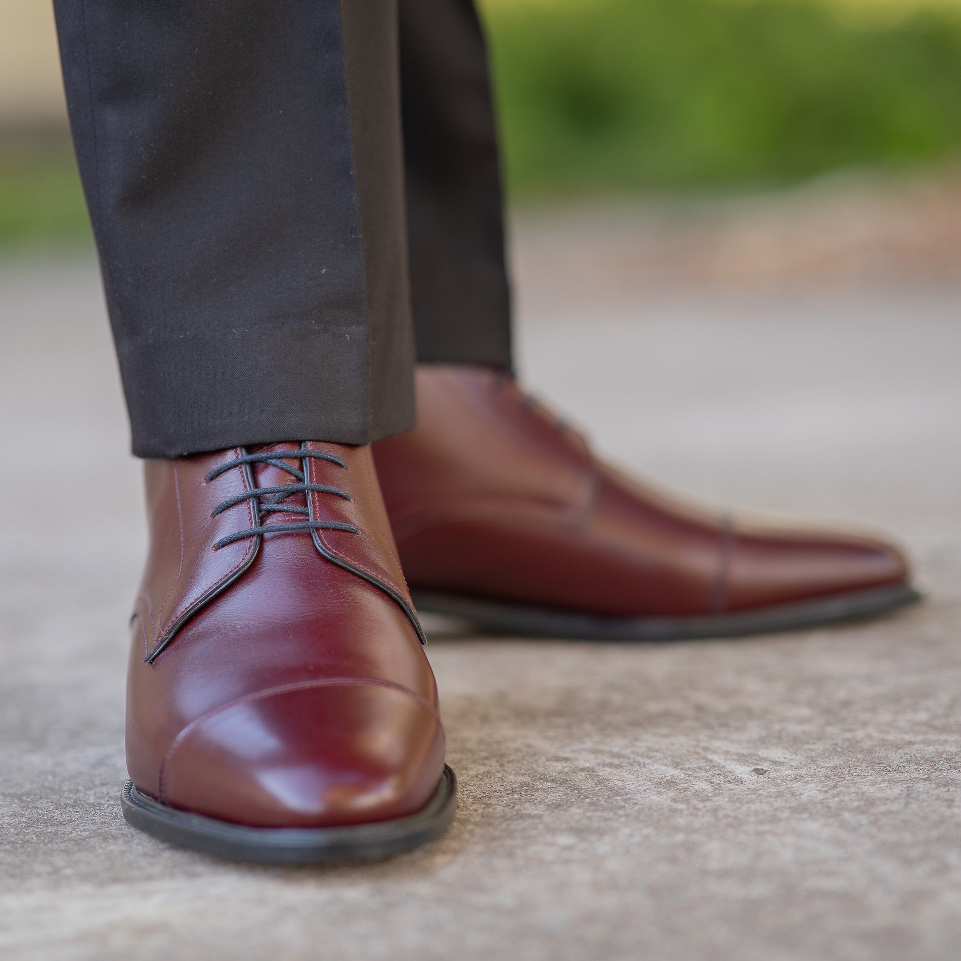 Burgundy lace up boots with front lace fastening and worn with dress suit