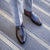 Penny loafer for men paired with stripped grey bespoke tailored fit suit for the office.