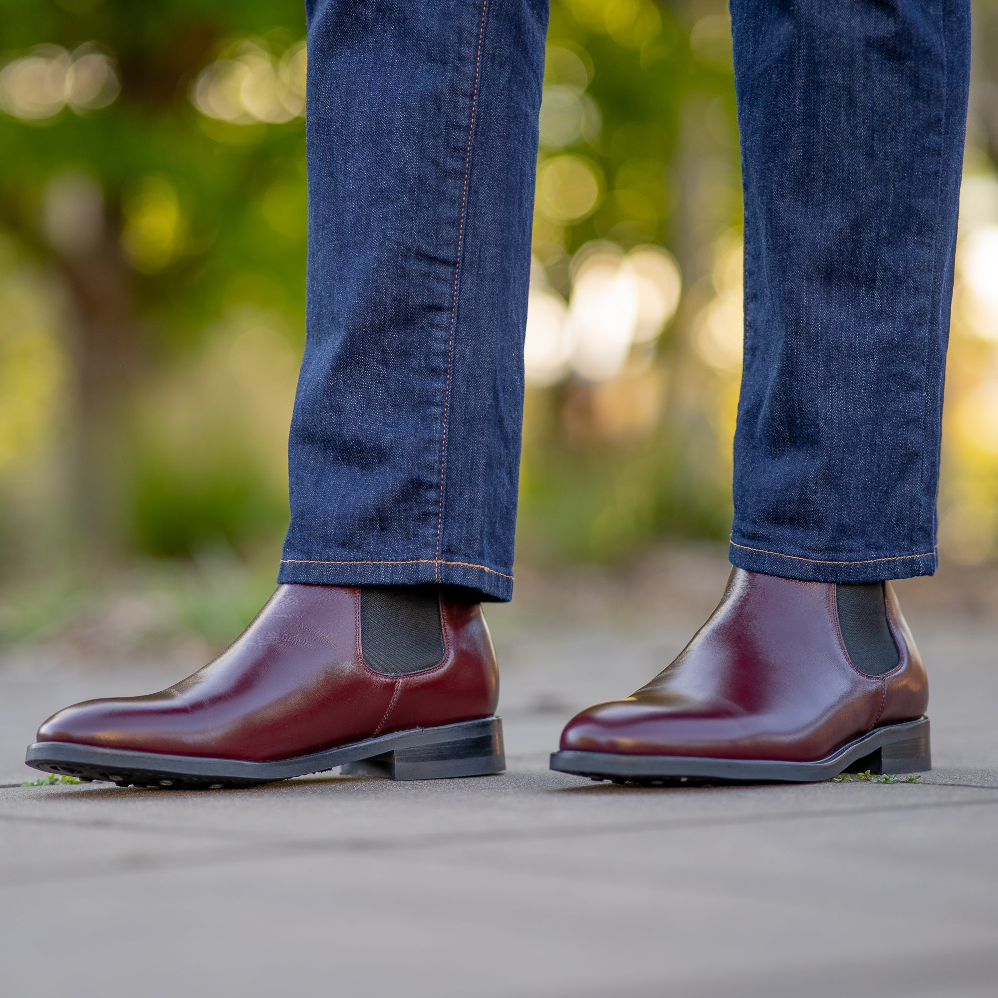 Chelsea boots burgundy paired with straight jeans and pattern shirt for smart casual look