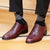 Burgundy wingtip shoes with broguing paired nicely with suit for formal event