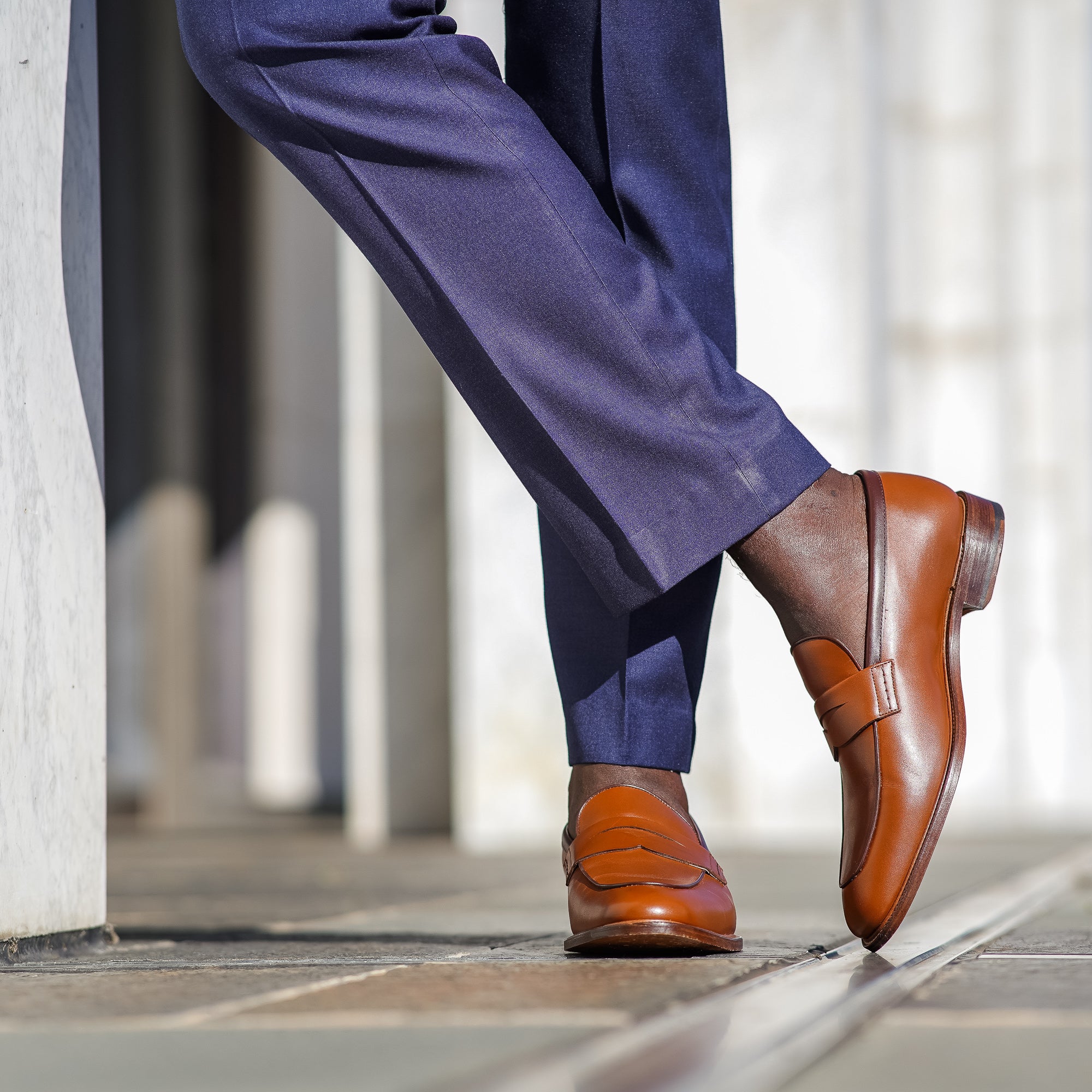 Tan penny loafers paired with slim fit 100% merino wool suit pant