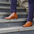 Mens tan dress boots paired with caramel coloured tailored three-piece suit 