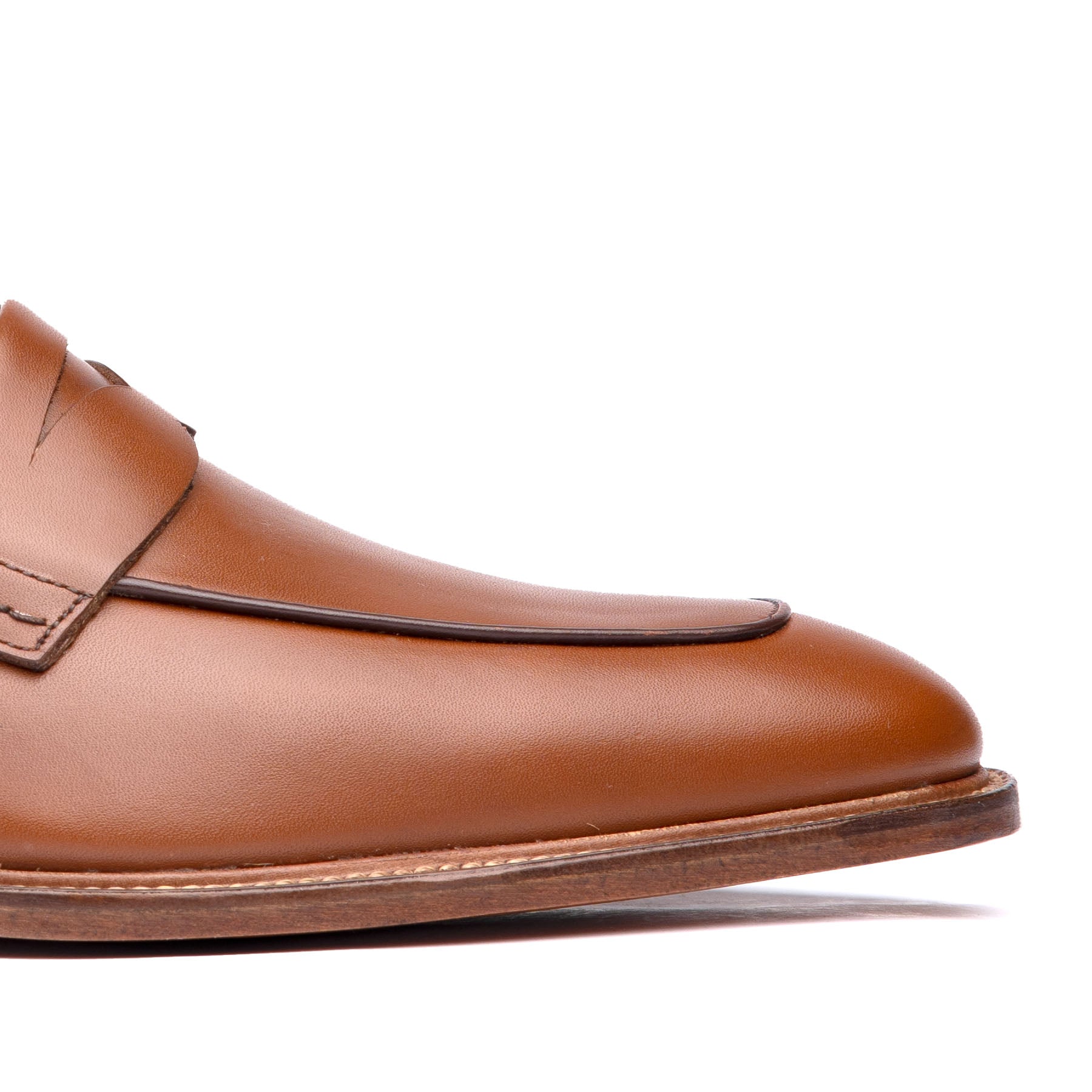 Tan penny loafers featuring luxurious full grain calfskin leather upper 