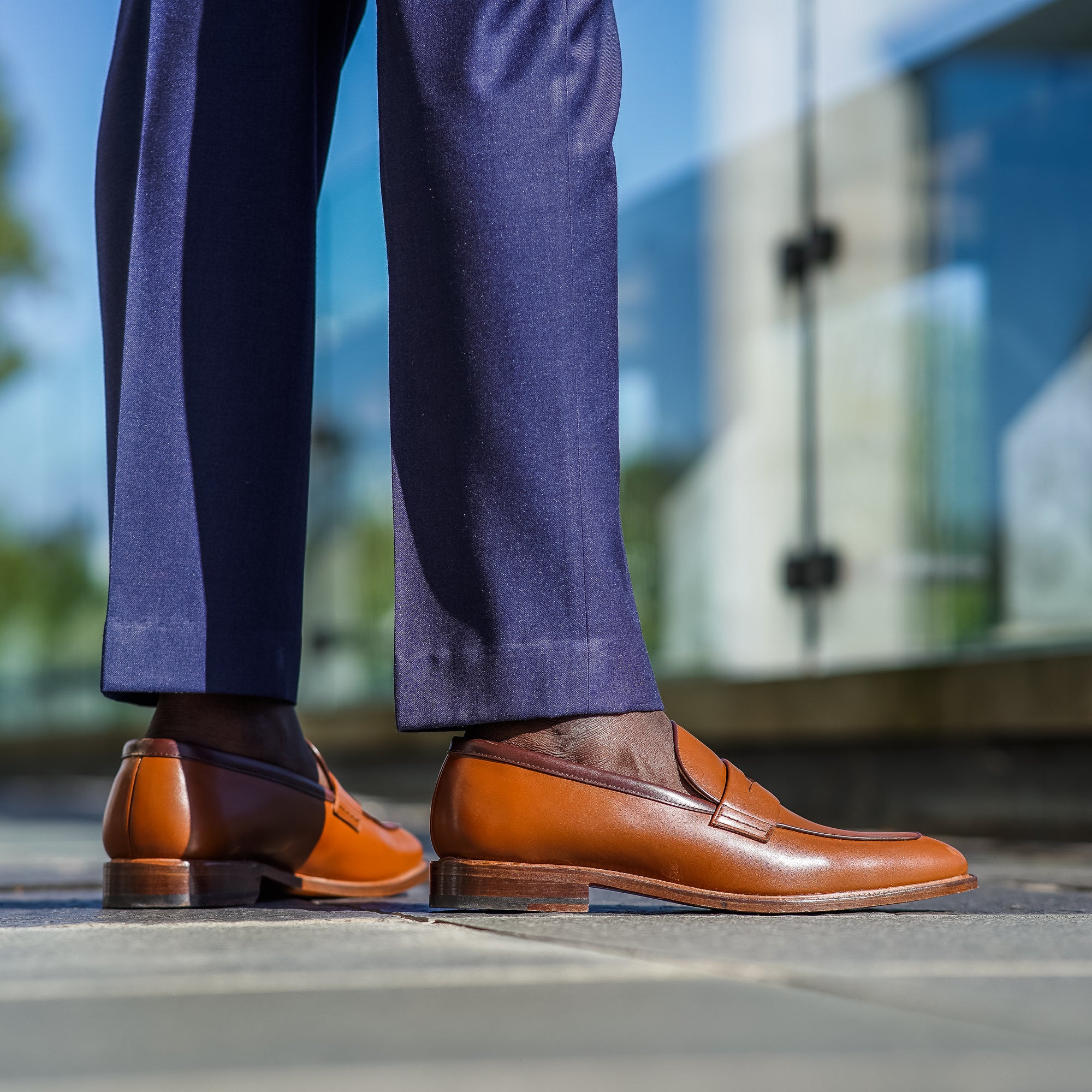 Mens tan loafers shoes paired with bespoke navy suit and Rolex watch