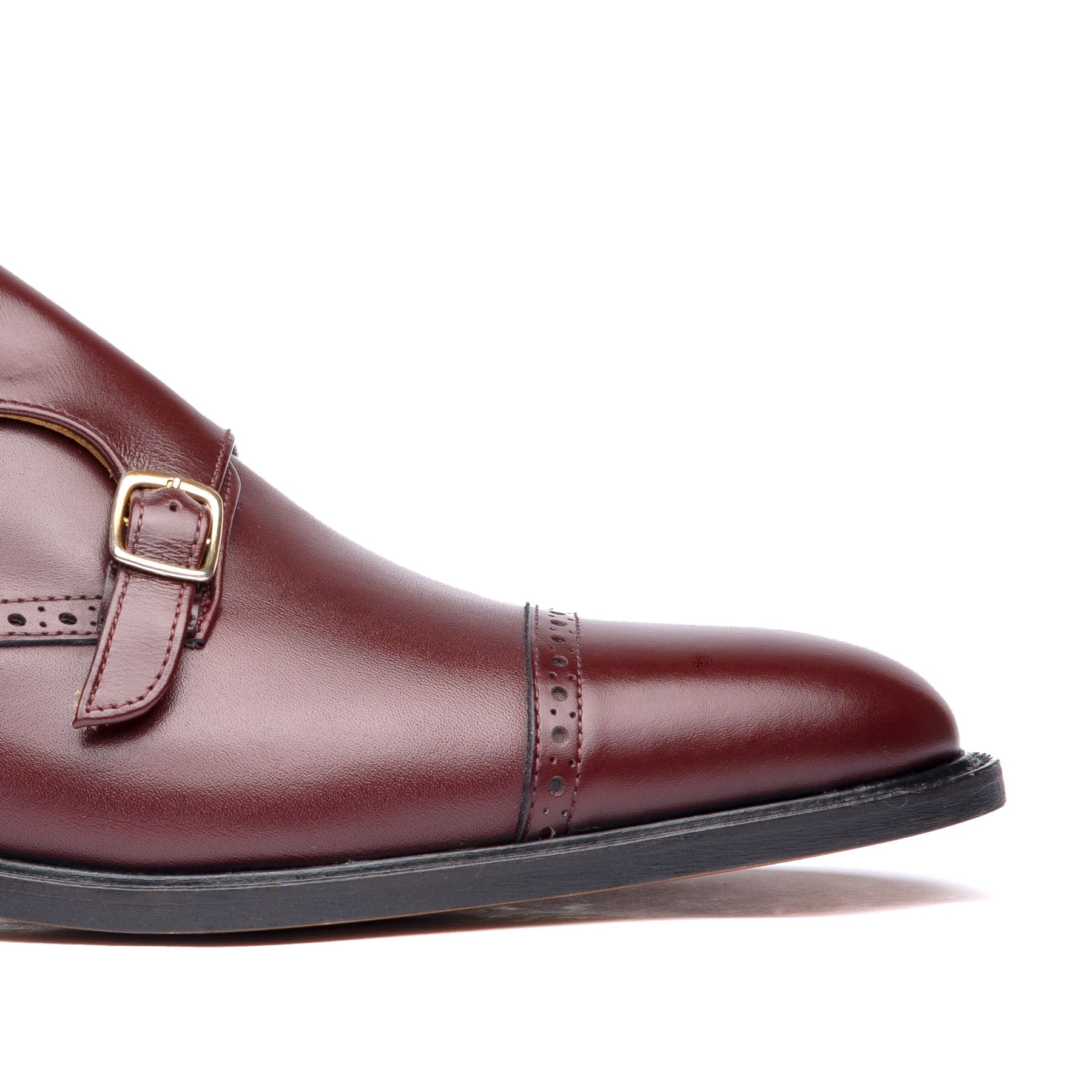 Burgundy monk strap shoes made with aniline dyed leather with brogues at the cap toe