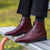 Oxblood dress boots paired with bespoke suit and Rado watch