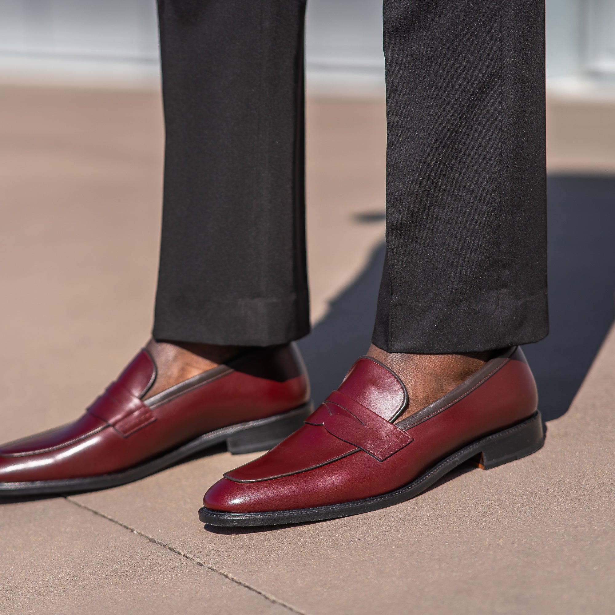 Burgundy penny loafers with blake rapid stitched construction worn without socks