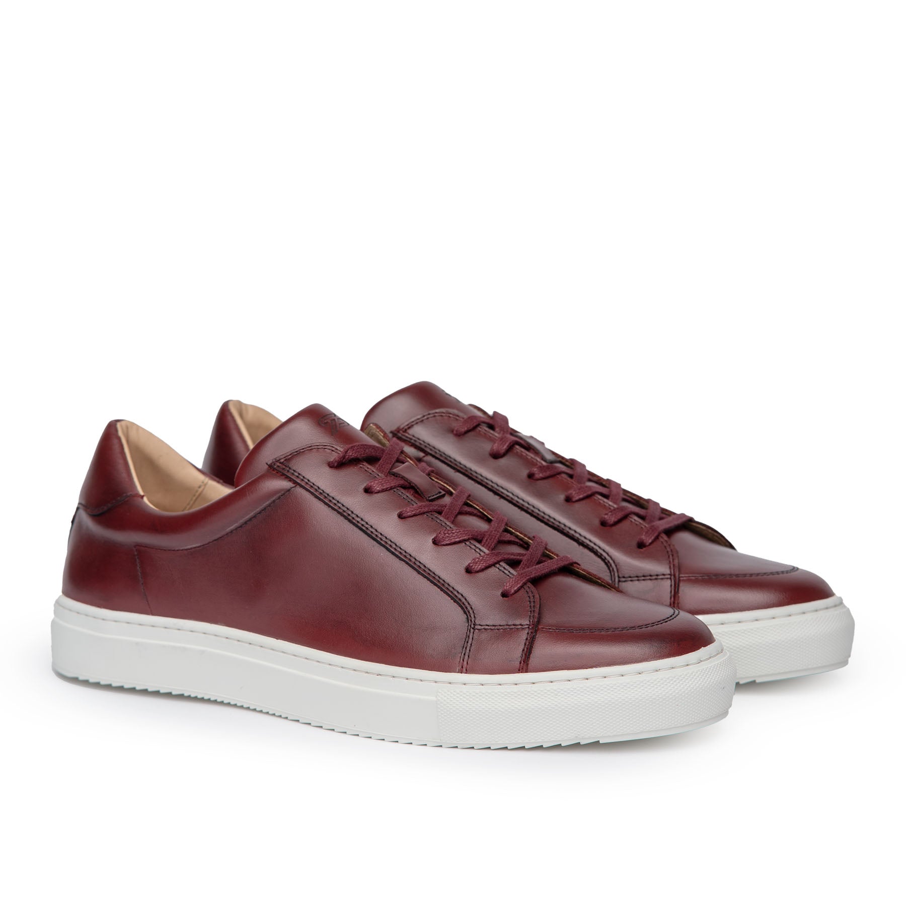 Shop oxblood sneakers featuring full grain leather and minimalist low top design