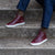 Red leather sneakers mens perfectly styled with black tucker jacket and chinos.