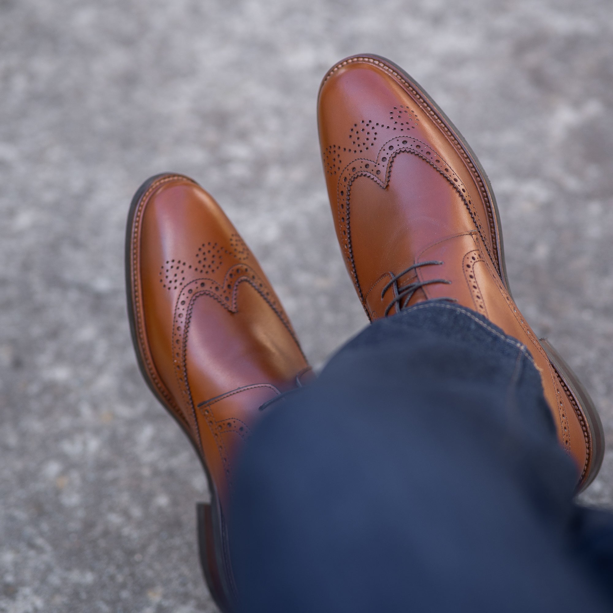 Mens boots tan leather  with brogues detailing paired with navy blue denim