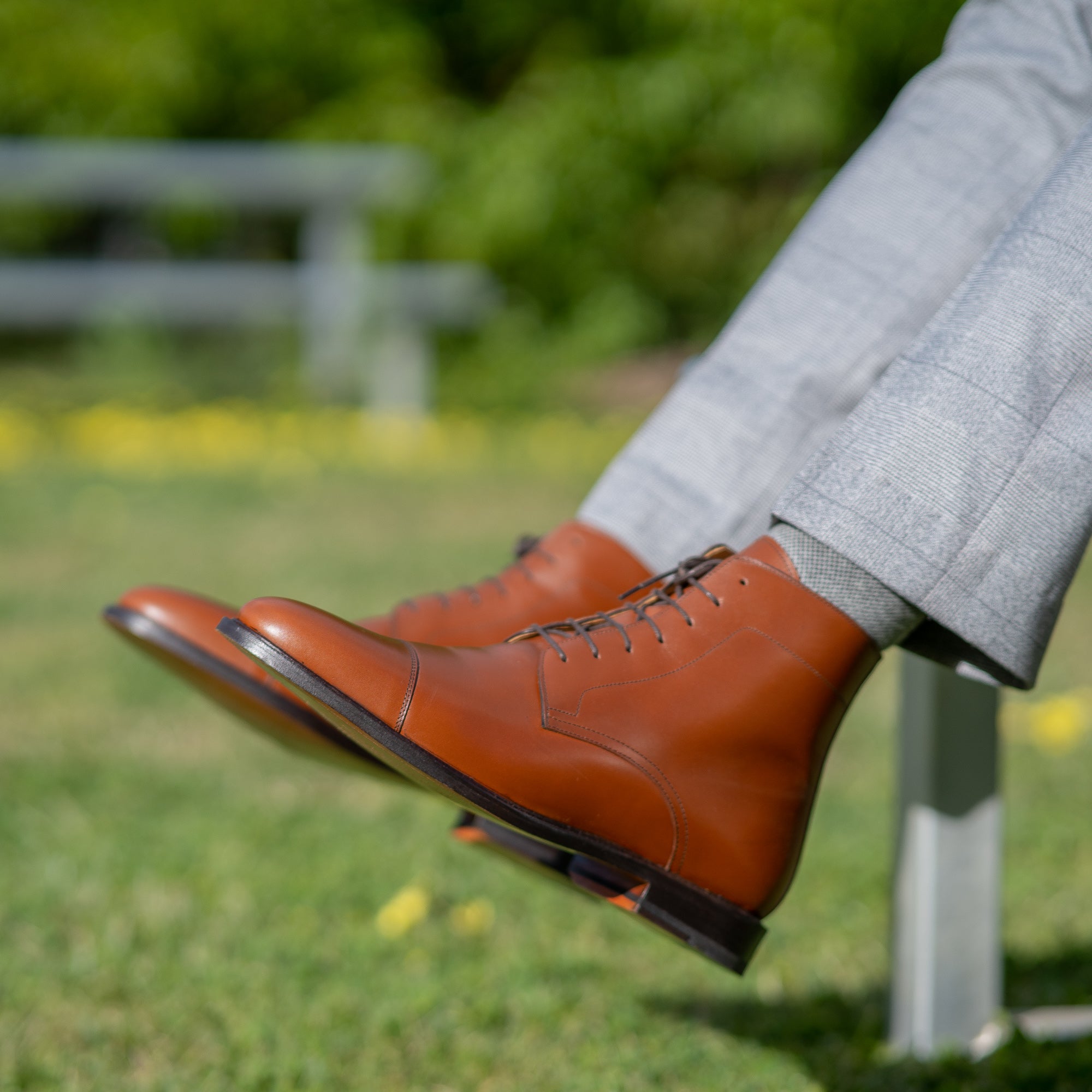 Mens light tan dress boots featuring lace up fastening and worn with gent tailored button plain suit