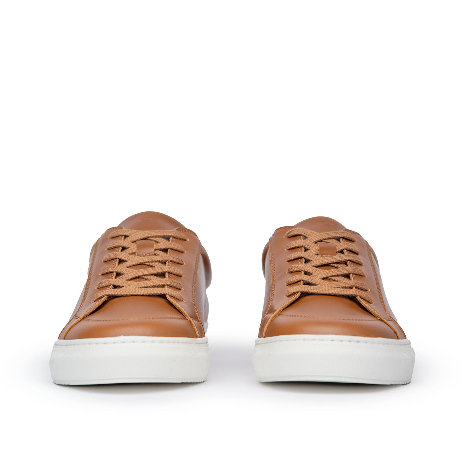 Tan trainers featuring low top design and white rubber sole for comfort

